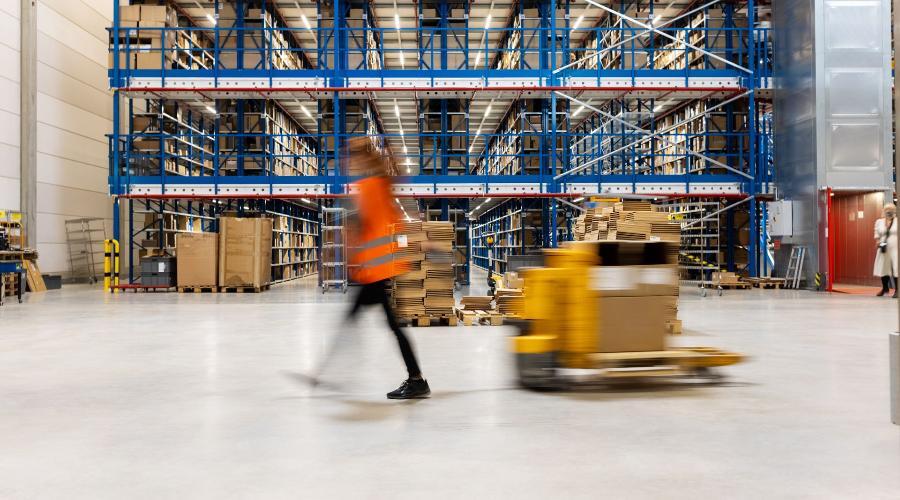 Female warehouse worker pulling pallets
