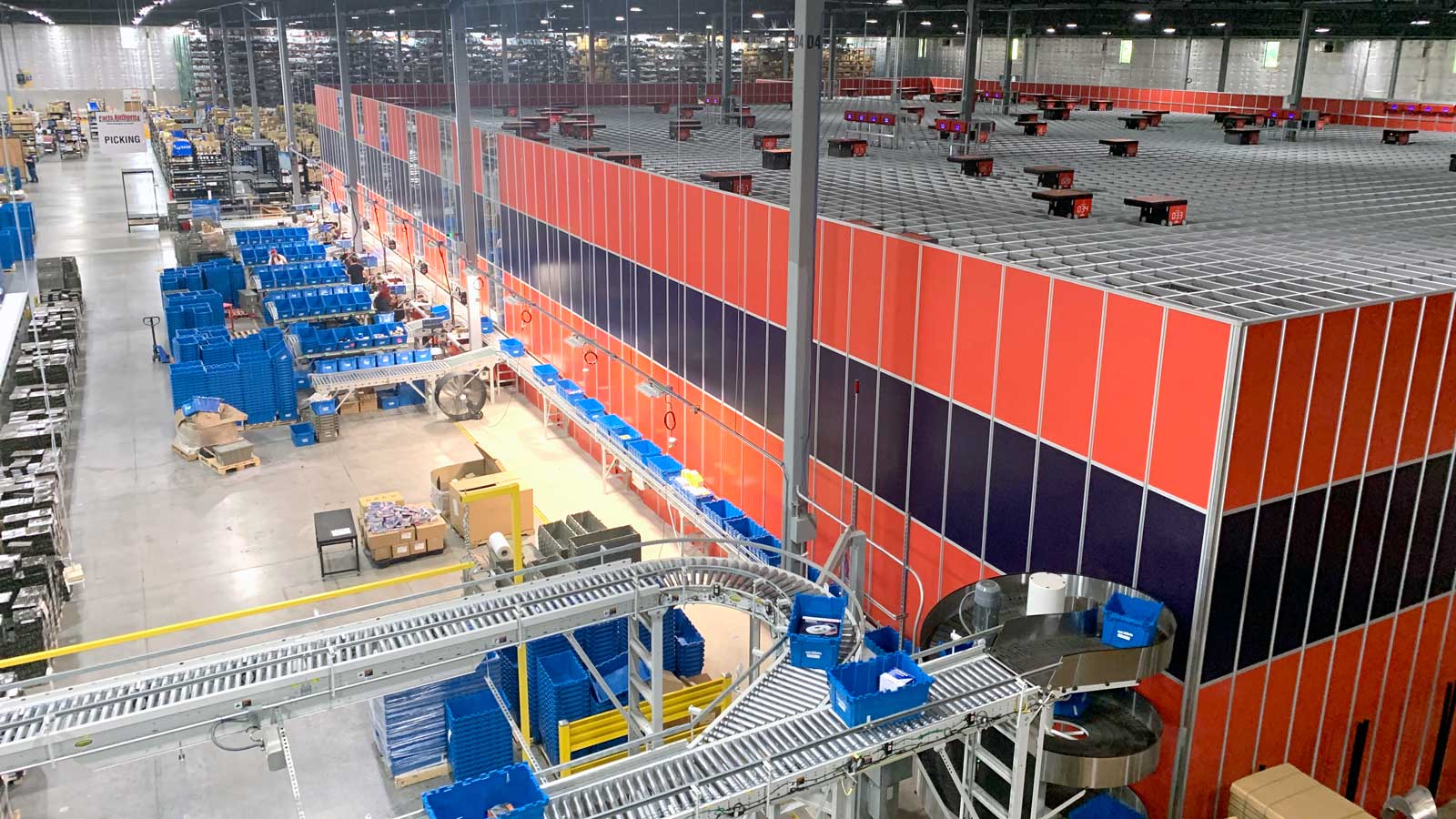 A high level view of a warehouse with AutoStore installed along with conveyor technology