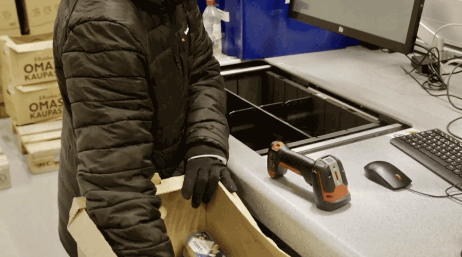 Person picking inventory from AutoStore CarouselPort at Kesko in Finland. Image.