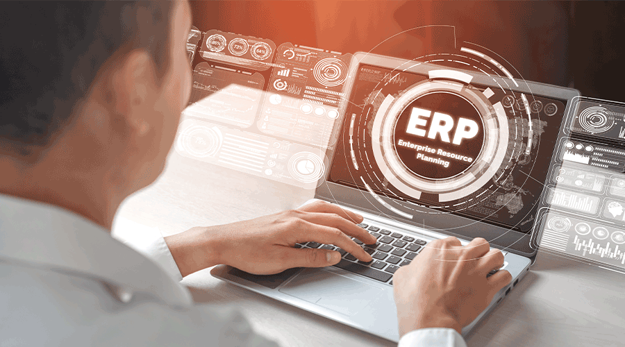 Man at desk viewing an ERP system. Image.