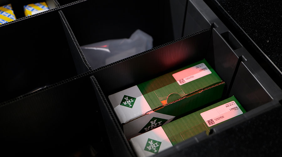 Pick-to-light system illuminating product in AutoStore Bin