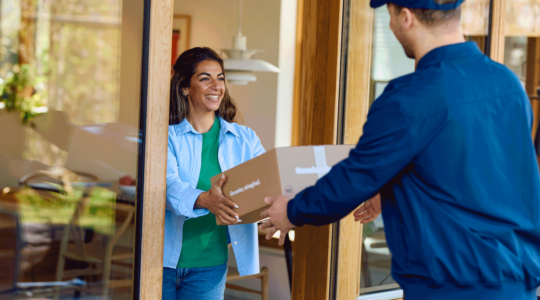Man delivering a package to a woman.