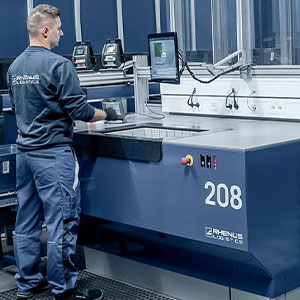 Rhenus Logistics employee fulfilling order from AutoStore system workstation. Image.